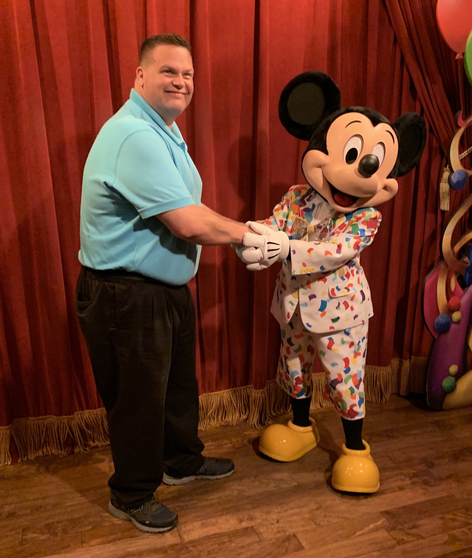 Kris shaking hands with Mickey Mouse